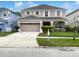 Charming two-story home with a well-manicured lawn, inviting landscaping, and a double-car garage enhancing curb appeal at 2007 Rain Dance Pl, Brandon, FL 33510