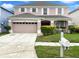 Attractive two-story home with well-kept landscaping, a spacious driveway, and a welcoming front entrance at 2007 Rain Dance Pl, Brandon, FL 33510