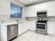 Well-lit kitchen featuring stainless steel appliances, white cabinetry, and tile backsplash at 2007 Rain Dance Pl, Brandon, FL 33510