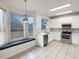 Bright kitchen with stainless steel appliances, white cabinets, and a cozy window bench at 2007 Rain Dance Pl, Brandon, FL 33510