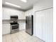 Modern kitchen with stainless steel appliances and white cabinetry at 2007 Rain Dance Pl, Brandon, FL 33510