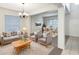 Inviting living room with neutral tones, plush seating, and a dining area filled with natural light, ideal for relaxation at 2007 Rain Dance Pl, Brandon, FL 33510