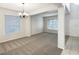 Bright, spacious living room with new carpeting, white columns, and abundant natural light at 2007 Rain Dance Pl, Brandon, FL 33510