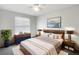 Relaxing main bedroom with a plush bed, modern decor, and a view of the outdoors through bright windows at 2007 Rain Dance Pl, Brandon, FL 33510