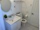 Bathroom featuring a round mirror and modern fixtures at 681 Dalton Blvd, Port Charlotte, FL 33952