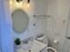 Clean bathroom featuring a round mirror and modern fixtures at 681 Dalton Blvd, Port Charlotte, FL 33952