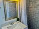 Bathroom featuring a gray subway tile surround, sleek vanity, and updated fixtures at 681 Dalton Blvd, Port Charlotte, FL 33952