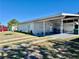 Exterior of home with a well-maintained lawn and an attached carport on a sunny day at 681 Dalton Blvd, Port Charlotte, FL 33952