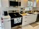 Bright, updated kitchen with stainless steel appliances, white cabinets, and modern fixtures at 681 Dalton Blvd, Port Charlotte, FL 33952