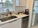 Modern kitchenette area with stainless steel appliances, quartz countertops, and sink at 681 Dalton Blvd, Port Charlotte, FL 33952