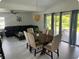 Open-concept living room with dining area and sliding glass doors to backyard at 681 Dalton Blvd, Port Charlotte, FL 33952