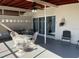 Spacious covered patio with seating, perfect for outdoor living and entertaining, with yard access at 681 Dalton Blvd, Port Charlotte, FL 33952