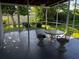 Comfortable screened patio features a table and chairs, ideal for enjoying the outdoors at 681 Dalton Blvd, Port Charlotte, FL 33952