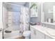 Cozy bathroom with a combined shower and tub, white vanity, and decorative seashell-themed accents at 10764 70Th Ave # 3305, Seminole, FL 33772