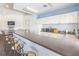 Community kitchen and bar area featuring appliances, generous counter space and bar stool seating at 10764 70Th Ave # 3305, Seminole, FL 33772