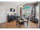 Charming dining area features a glass table, bar with wine storage, and bright windows at 10764 70Th Ave # 3305, Seminole, FL 33772