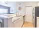 Bright kitchen with granite countertops, stainless steel appliances, white cabinets, and tile flooring at 10764 70Th Ave # 3305, Seminole, FL 33772