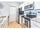Well-equipped kitchen with granite countertops, stainless steel appliances, and white cabinetry at 10764 70Th Ave # 3305, Seminole, FL 33772