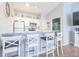 Kitchen with white cabinets, granite countertops, stainless steel appliances, and bar seating at 10764 70Th Ave # 3305, Seminole, FL 33772