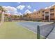 Enjoy a community tennis court adjacent to lovely condos with palm trees and blue skies at 10764 70Th Ave # 3305, Seminole, FL 33772