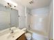 Well-lit bathroom features single sink vanity, bathtub and shower combination at 12092 Rockford St, Spring Hill, FL 34608