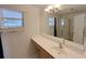 Bathroom with large mirror, single sink vanity, and glass-enclosed shower at 12092 Rockford St, Spring Hill, FL 34608