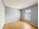 Bedroom featuring wood floors, light blue walls, window and a closet at 12092 Rockford St, Spring Hill, FL 34608