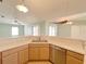 Kitchen area with light cabinets, stainless steel appliances, and a peninsula counter for casual dining at 12092 Rockford St, Spring Hill, FL 34608