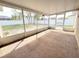 Enclosed lanai with carpeted floor and screens at 12092 Rockford St, Spring Hill, FL 34608