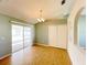 Bright living room with sliding glass doors leading to an enclosed lanai and hardwood floors at 12092 Rockford St, Spring Hill, FL 34608