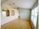 Spacious living room with hardwood floors, neutral paint and arched doorways, providing an open feel at 12092 Rockford St, Spring Hill, FL 34608