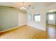 An open living room featuring light-colored walls, wood flooring, and arched entryway to other rooms at 12092 Rockford St, Spring Hill, FL 34608