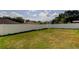 Spacious backyard featuring lush green grass and white vinyl fence at 25242 Carnation Sedge Way, Land O Lakes, FL 34639