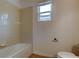 Cozy bathroom featuring tiled shower and bath, along with a window for natural light at 25242 Carnation Sedge Way, Land O Lakes, FL 34639