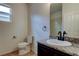 Well-lit bathroom featuring granite counters, dark wood cabinets, and a modern black faucet at 25242 Carnation Sedge Way, Land O Lakes, FL 34639