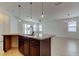 Modern kitchen features granite countertops, dark cabinets and breakfast bar at 25242 Carnation Sedge Way, Land O Lakes, FL 34639