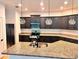 Modern kitchen features granite countertops, stainless appliances, dark cabinets, and pendant lighting at 25242 Carnation Sedge Way, Land O Lakes, FL 34639