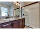 Bright bathroom features dual sinks, granite counters, modern lighting and a framed shower at 25242 Carnation Sedge Way, Land O Lakes, FL 34639