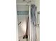 Bathroom with white tiled shower, grab bars, shower curtain, and shower head at 1420 Citrus St, Clearwater, FL 33756