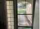 View of the front yard from inside the house through an entryway door with glass block panes at 1420 Citrus St, Clearwater, FL 33756
