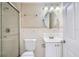 Cozy bathroom featuring a walk-in shower, vanity sink and modern fixtures at 7708 Belah Dr, New Port Richey, FL 34653