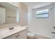 Bathroom featuring a shower-tub combination, a white sink vanity, and modern fixtures at 7708 Belah Dr, New Port Richey, FL 34653