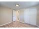This bedroom has a big sliding door closet and hardwood floors at 7708 Belah Dr, New Port Richey, FL 34653