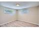 This bedroom has two windows providing great natural light and beautiful hardwood floors at 7708 Belah Dr, New Port Richey, FL 34653