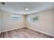 This bedroom has two windows providing great natural light and beautiful hardwood floors at 7708 Belah Dr, New Port Richey, FL 34653