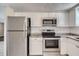 Updated kitchen with stainless steel appliances, granite countertops, and white subway tile backsplash at 7708 Belah Dr, New Port Richey, FL 34653