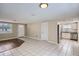 Bright living room flowing into the kitchen with tiled flooring and stainless steel appliances at 7708 Belah Dr, New Port Richey, FL 34653