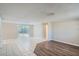 Living room featuring tiled flooring, a sliding glass door, and neutral paint at 7708 Belah Dr, New Port Richey, FL 34653
