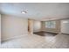 Spacious living room featuring tiled flooring, natural light, and neutral paint at 7708 Belah Dr, New Port Richey, FL 34653