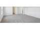 Spacious bedroom featuring neutral carpet, white walls, and a large window offering plenty of natural light at 1878 Draughton Dr, Zephyrhills, FL 33541